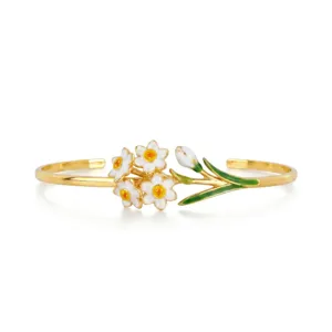 Stainless steel open cuff bracelet featuring elegant enamel daffodil flowers and green leaves.