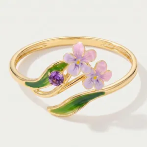 Detailed close-up of the elegant enamel flower ring featuring vibrant purple and pink petals.