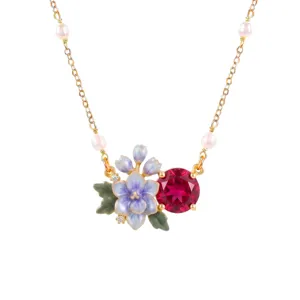Gold necklace featuring pearl accents, hand-painted blue enamel flowers, and a red crystal stone.