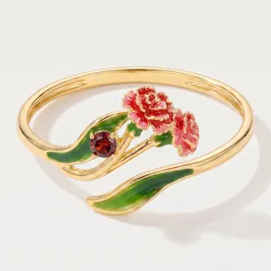 Gold plated open ring featuring red enamel flower and green leaf design with gemstone.
