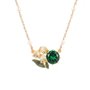 Exquisite lily of the valley necklace detail with pearls, green gemstone, and gold chain.