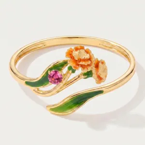 Close-up detail of the elegant gold-plated floral ring featuring colorful enamel flowers and stone.