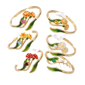 December flower ring set featuring delicate enamel floral designs, gold-plated forest style jewelry.