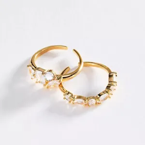 Detail view of exquisite gold-plated stainless steel open rings with sparkling clear zirconia stones.