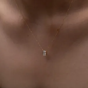 Delicate bezel-set zircon pendant necklace, minimalist gold-tone chain for daily wear detail shot.