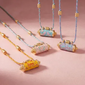 Detailed view of fashion animal prayer wheel braided rope necklaces with shiny gold plating.
