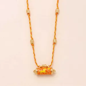 Gold plated braided rope necklace featuring a detailed cylindrical talisman charm pendant.