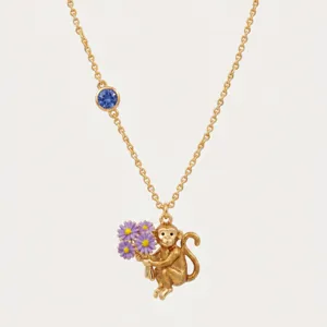 Vergulde dierenriem aap bloem hanger ketting met blauw kristal detail prachtig.