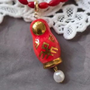 Gros plan détaillé du pendentif collier poupée russe vintage élégante avec perle.