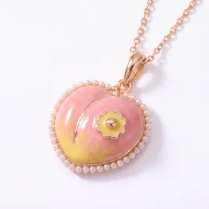 Exquisite peach pendant necklace with faux pearl border and sweet fruit design detail.