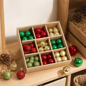 Detailed view of assorted Christmas baubles in a compartmentalized box with pinecones.