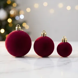 Close-up view of luxury burgundy velvet Christmas ornaments, soft texture and gold hanging caps.