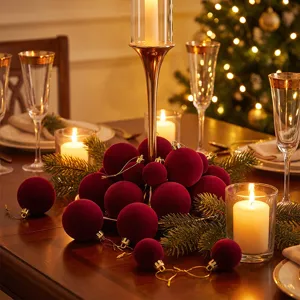 Detail view of wine red velvet Christmas balls with golden caps for holiday decoration.