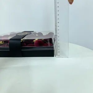 Detail shot showing the height measurement of the boxed burgundy flocked Christmas balls.
