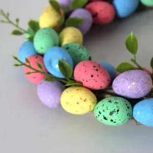 Easter egg wreath detail shot, colorful speckled eggs and green leaves, perfect home decor.