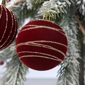 Χριστουγεννιάτικη μπάλα με χρυσές ρίγες γκλίτερ, κόκκινο βελούδινο στολίδι για το δέντρο.