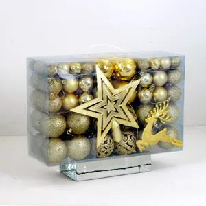 Detailansicht des goldenen Christbaumkugel-Sets in transparenter PVC-Box mit Stern und Elch.
