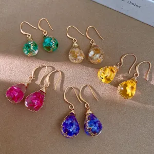 Detailed view of bohemian resin dried flower teardrop earrings in multiple vibrant colors.