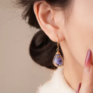 Stunning detail view of the handmade resin flower teardrop earring showcasing delicate floral charm.
