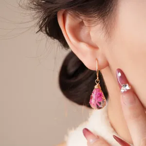 Exquisite bohemian resin dried flower teardrop earrings detail view, elegant vintage style.