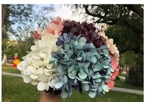 Detailed close-up view of artificial autumn hydrangea bouquet, silk flower for wedding decor.