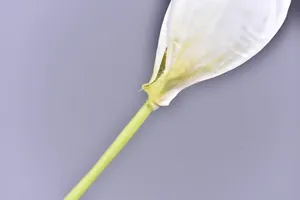 Close-up detail of artificial freesia flower petal and stem joint craftsmanship texture.