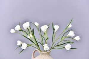 Close up detail of artificial white crocus flowers in vase for home decor and styling.