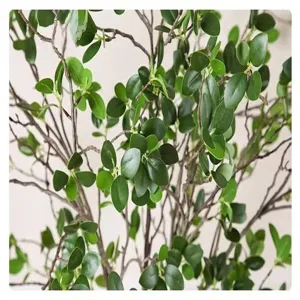 Artificial green plant detail shot featuring simulated Milan leaves on branches for home decor.