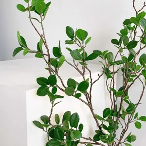 Detailed shot of artificial green plant branch, faux leaf foliage for home wedding decor.