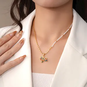 Exquisite half pearl and gold chain necklace featuring a colorful gemstone pony pendant detail.
