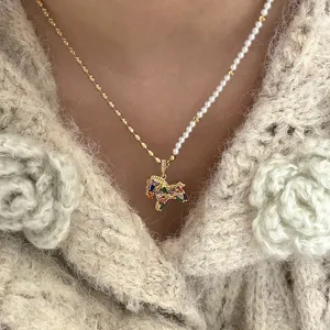 Gros plan détail du collier pendentif perle cheval zodiaque zircon coloré français.
