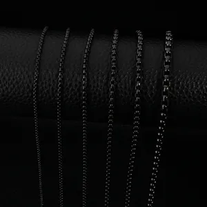 Close-up detail shot of six different thickness black titanium steel chains on display roll.