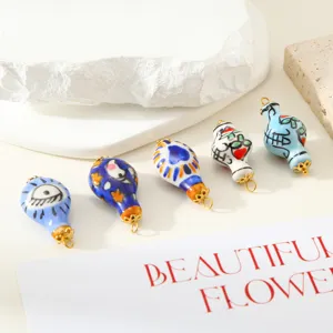 Close-up of artistic ceramic bottle pendants featuring unique hand-painted patterns for DIY crafts.