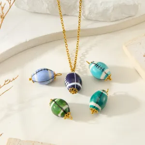 Close-up detail of colorful rugby shaped ceramic beads pendant necklace DIY accessories.