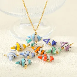 Close-up detail of colorful ceramic tropical fish pendants and stainless steel chain jewelry accessories.