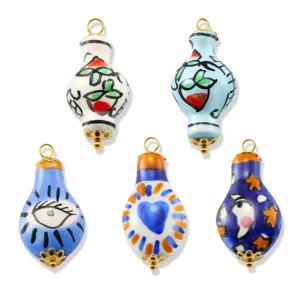 Handmade ceramic art pendants with gold hardware, colorful abstract patterns for jewelry.