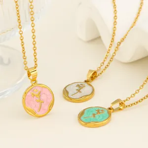 Close-up detail shot of stainless steel gold-plated necklaces featuring colorful enamel tulip pendants.