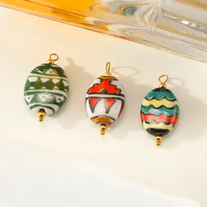 Hand-painted ceramic oval pendant close-up, featuring colorful geometric DIY jewelry charm.