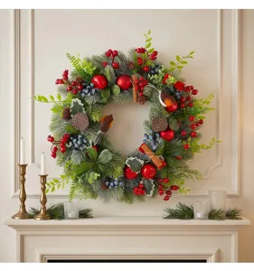 Detail shot of Christmas wreath featuring pine needles, red berries, and artificial robins.