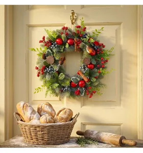 Artificial Christmas wreath with pine needles, red berries and robin for door hanging decoration.