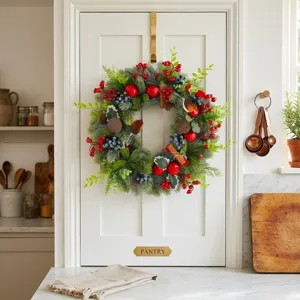 Christmas artificial pine wreath with red berries robins and pinecones for holiday door decoration