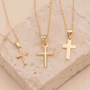 Elegant gold cross pendant necklace set featuring three distinct minimalist styles for women.