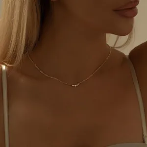 Delicate gold-plated clavicle necklace with sparkling cubic zirconia stones for women.