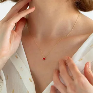 Minimalist gold chain necklace with red heart pendant, elegant French retro style jewelry.