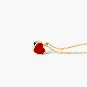 Minimalist gold chain necklace with red heart pendant, elegant French retro style jewelry.