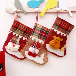Christmas stocking detail view, hanging holiday gift bag with cute plush Santa snowman