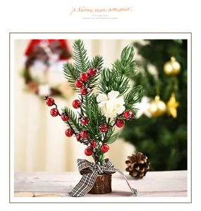Mini Christmas tree decoration desktop ornament with red berries and pine branches for home.