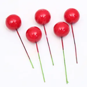 Vista detallada de 5 bayas rojas artificiales de espuma para pasteles de navidad y DIY.