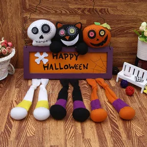 Halloween plush hanging decoration detail featuring cute skeleton black cat and pumpkin.