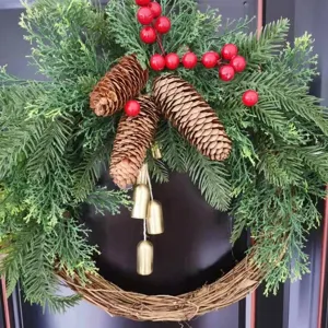 Christmas wreath with pine cones red berries and gold bells for holiday door hanging decor